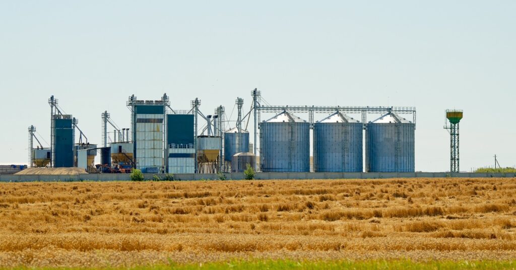 Numerous storage tanks sitting next to each other. The tanks are different sizes and shapes, and have different numbers on them.